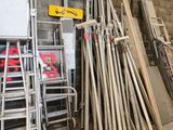 a lot of wooden boards and ladders in a warehouse