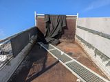 a black tarp on the roof of a building