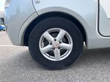 a close up of a car ' s tire on a parking lot