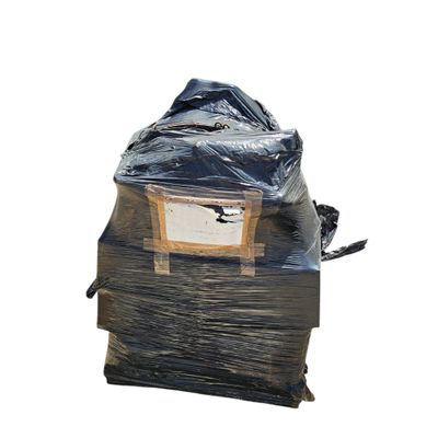 a pile of books wrapped in plastic and sitting on top of each other