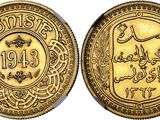 a gold coin with arabic writing on it