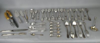 a lot of silverware on a table with a knife, fork, spoon and knife rest