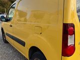 the back of a yellow van parked in a parking lot
