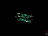 a close up of a green tourmaline on a black background
