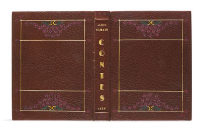 a brown leather book with gold trimming and a gold border