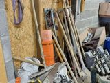 a pile of tools and tools in a garage