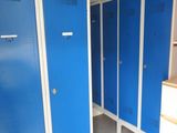 several blue lockers are lined up in a row in a room