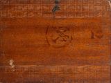 an old wooden box with writing on it sitting on a table