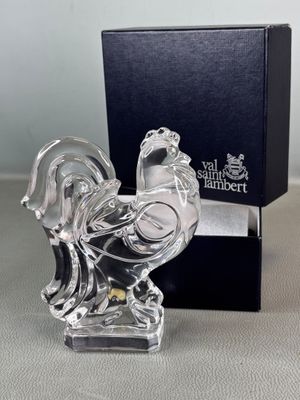 a glass figurine of a rooster on a table