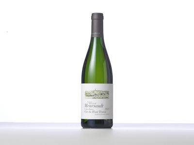 a bottle of white wine sitting on top of a table