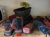 many different tools on a wooden shelf in a room