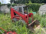 a red ski - door that is sitting in the grass