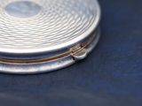 a silver plate with a gold ring on it