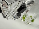 a glass vase filled with black olives next to a glass vase