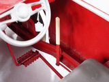 a red toy car with a steering wheel and a steering wheel
