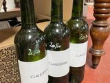 three bottles of wine sitting on a table next to a box of wine