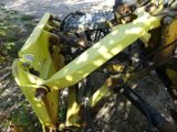 a close up of a yellow tractor with a chain attached to it