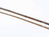 pair of wooden canes with handles on a white surface