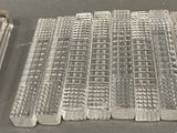several pieces of glass sitting on top of a table next to each other