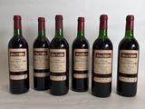 six bottles of wine are lined up in a row on a table