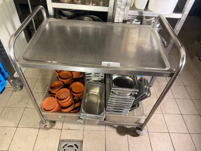 a metal cart with many pans and pans on it