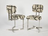a pair of chairs with a black and white design on them