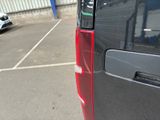 a black van parked in a parking lot next to a building
