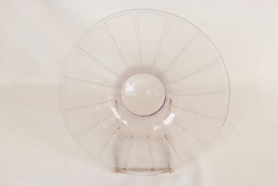 underside view of a clear glass vase with a white background