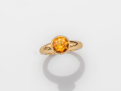 a gold ring with an oval citrine stone in the center