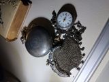 a clock that is on the wall next to a purse
