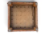 an overhead view of a wooden box on a white surface