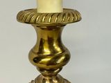 a candle that is sitting on a table next to a pair of earrings