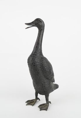 a statue of a duck that is standing in the snow