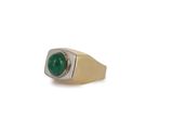 an image of a gold ring with a green stone on it