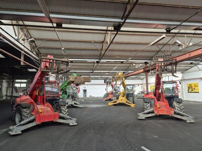 many machines that are parked inside of a building