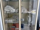 a glass cabinet with many items inside of it
