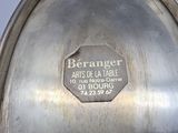 a silver plate that has a label on it