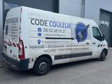 a white van that is parked in front of a building