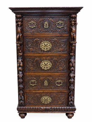 a wooden chest of drawers with ornate carvings and brass handles