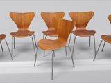 four wooden chairs with metal legs in a row on a white surface