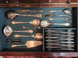 a lot of silver spoons and spoons in a drawer