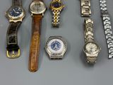 a lot of watches that are sitting on a table