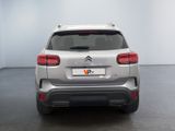 the rear end of a silver citrole parked in a room
