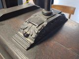 a close up of a metal object on top of a wooden table