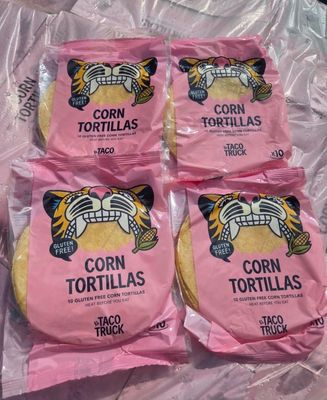 four bags of corn tortillas sitting on top of a plastic bag