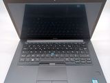 a laptop that is open on a white surface