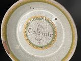 a white plate with a green and yellow design on it