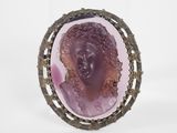 a close up of a ring with a face of a woman on it