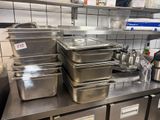 many pans and containers on the counter in the kitchen