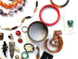 many different types of jewelry on a white surface